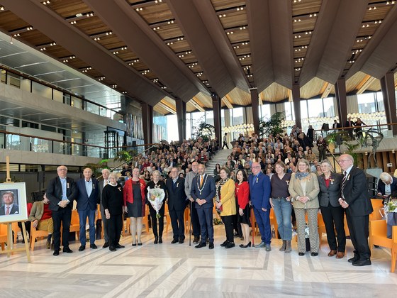 De 15 personen die een onderscheiding hebben gekregen staan in de hal van het stadhuis, met burgemeester Ahmed Marcouch in het midden.